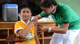 image of child in school getting dengue vaccine