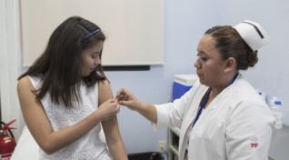 Image of a young woman getting a vaccine to discover the true value of vaccination