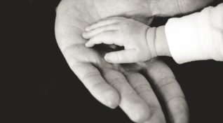 Image of hand reaching out, representing the community health projects funding offer from Break Dengue.