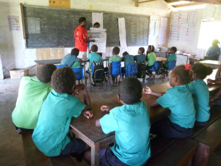 Red Cross volunteers in Vanuatu in a school teaching students about dengue. 