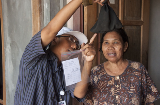 Image from one of the Wolbachia programs in Asia of a woman in Indonesia being shown the variety of mosquitoes caught during a monitoring program. Image from one of the Wolbachia programs in Asia of a woman in Indonesia being shown the variety of mosquitoes caught during a monitoring program.