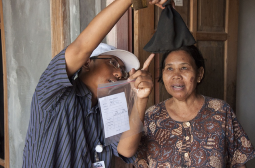 Image from one of the Wolbachia programs in Asia of a woman in Indonesia being shown the variety of mosquitoes caught during a monitoring program. 