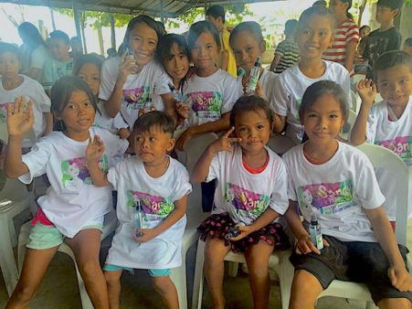 Image from the Sandy project expo featuring children in t-shirts from the dengue awareness campaign. 
